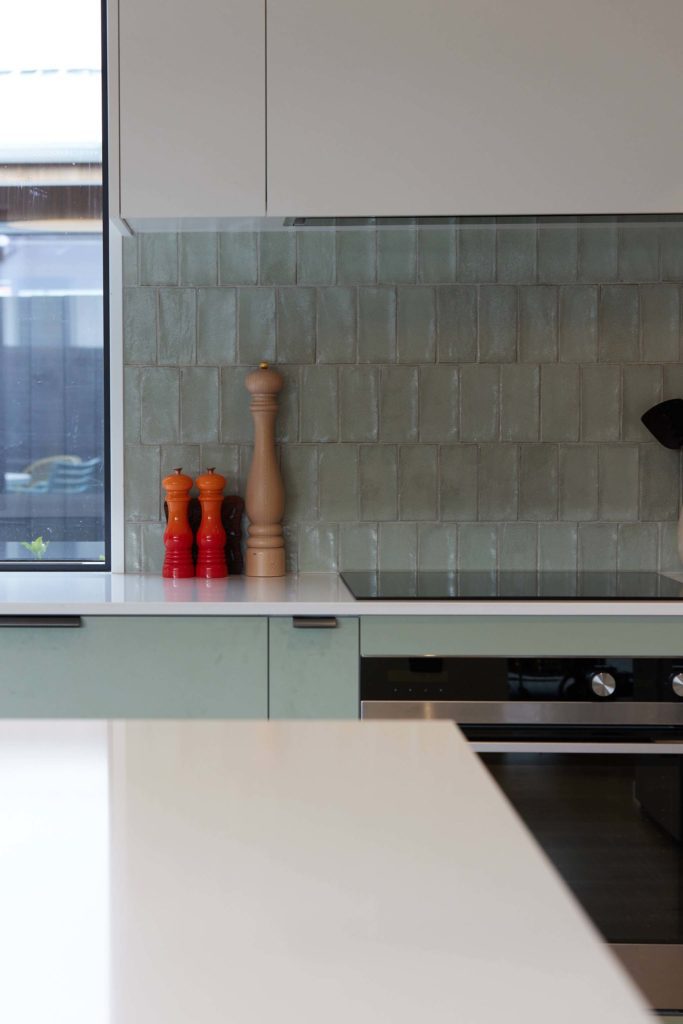 Green Kitchen featuring green tiled splash back. Designed and built by R&B Build Christchurch