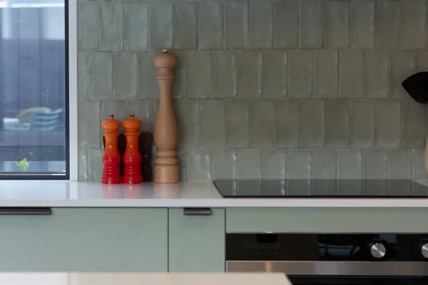 Green Kitchen featuring green tiled splash back. Designed and built by R&B Build Christchurch